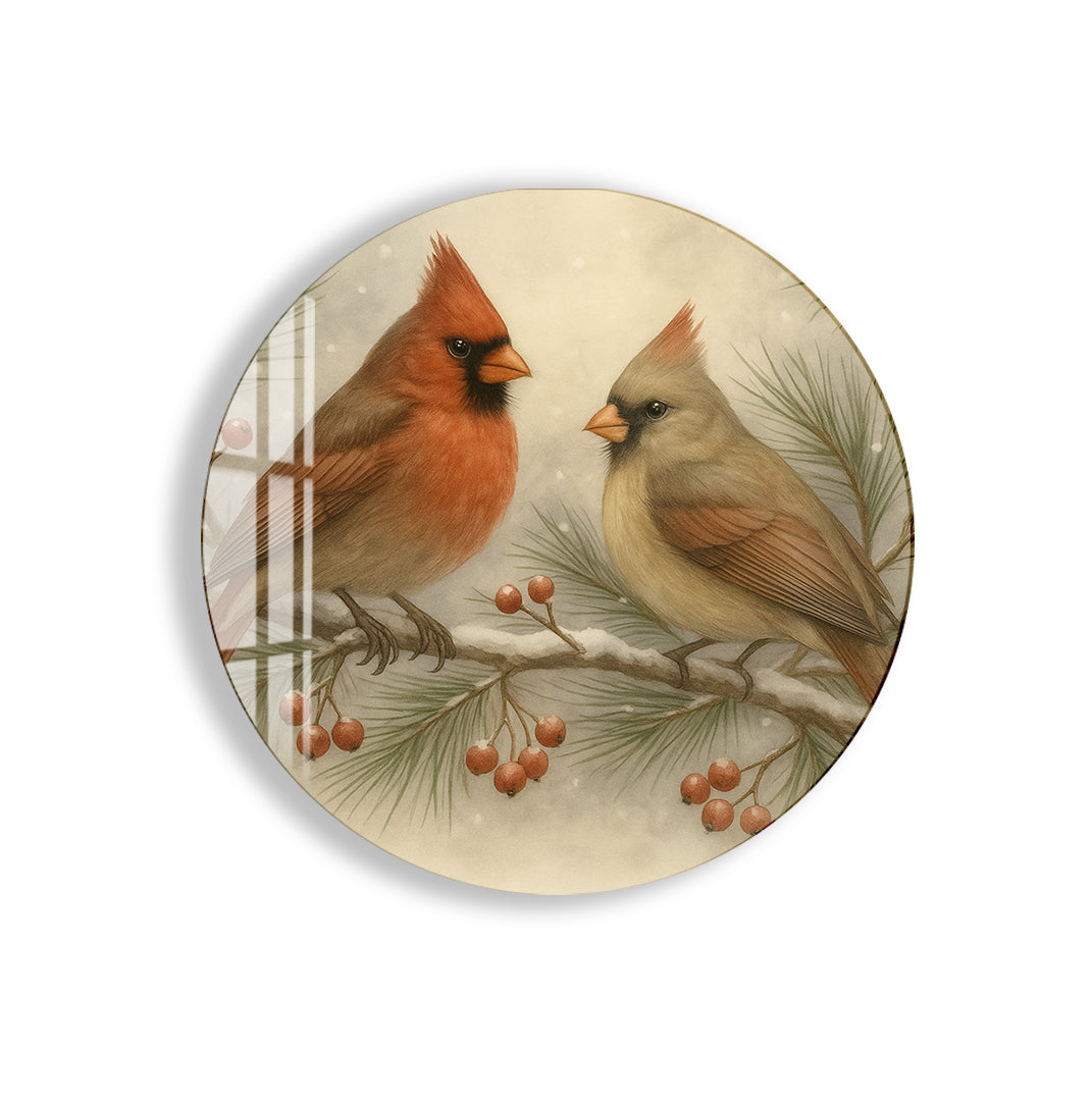 Two cardinals perched on a snowy pine branch with winter berries.