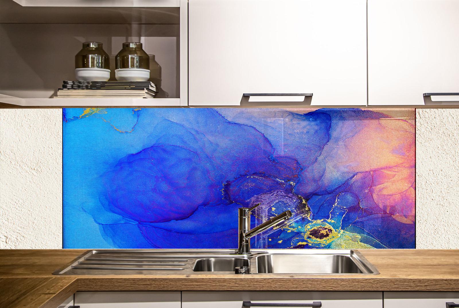 a kitchen with a colorful abstract mural on the wall behind the sink. The mural displays a vibrant mix of blue, purple, and orange colors, creating a lively and dynamic visual effect. The kitchen has white cabinets and a wooden countertop, providing a clean and modern aesthetic.