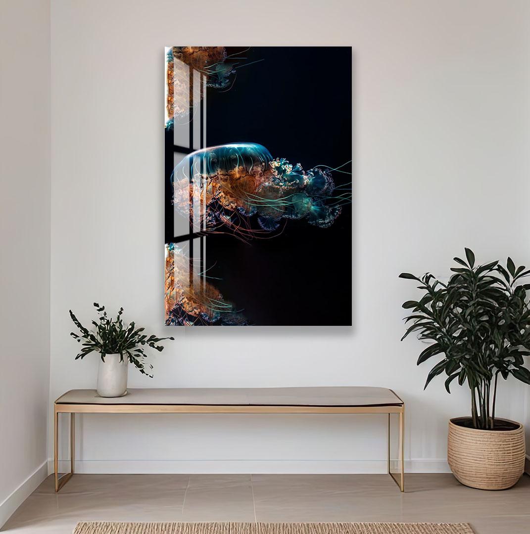 a large abstract painting of a jellyfish with vibrant colors and intricate patterns, hanging on a white wall above a wooden bench and a potted plant.