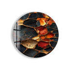 The image is an oval-shaped piece of art featuring a striking abstract design with a mix of black, orange, and gold colors. The design appears to be a combination of various shapes and textures, creating a visually captivating and dynamic composition.