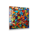 The image is a vibrant and colorful mosaic composed of numerous small, irregularly shaped pieces in a variety of bright and vivid colors, creating a visually striking and dynamic composition.