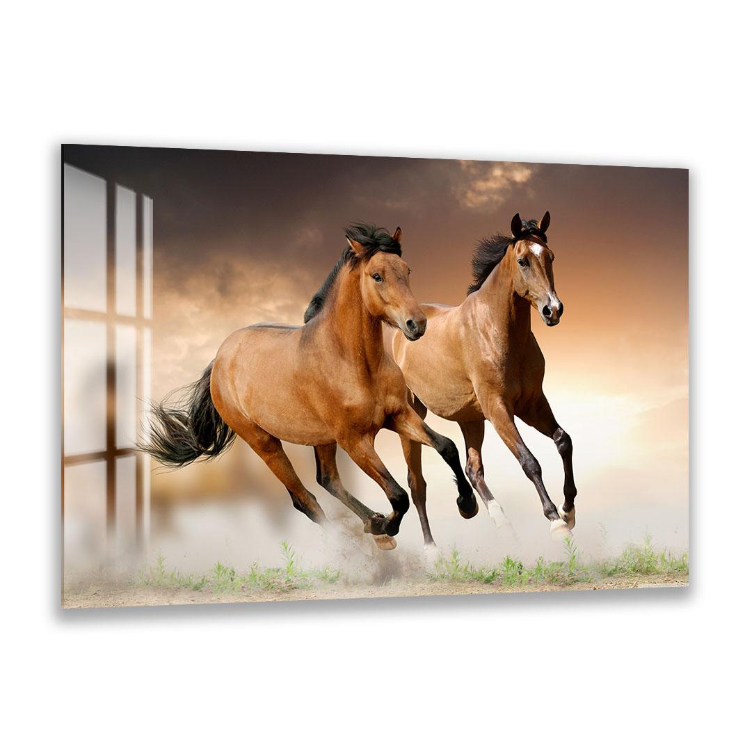 A close-up image of two leopards, one adult and one juvenile, resting together in a natural setting.