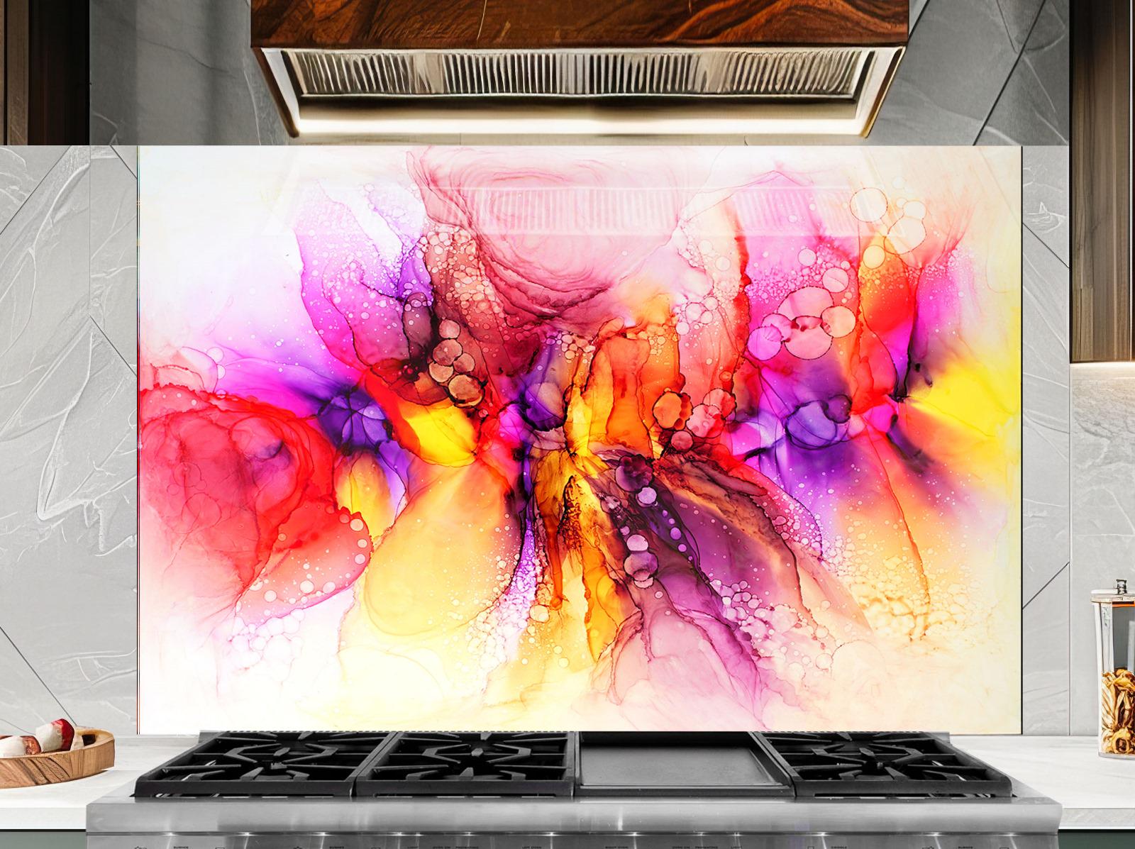 a vibrant abstract painting with a colorful, swirling design of pink, orange, yellow, and purple hues. The painting is displayed on a wall above a stovetop with a black oven hood.