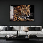 A large, striking photograph of a leopard is displayed on the wall above a white sofa in a modern living room setting.