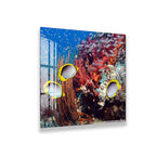 A vibrant underwater scene with three colorful fish swimming among a coral reef.