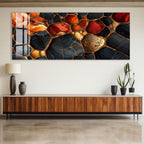 a large abstract painting with a striking color palette of red, orange, and black, displayed on a wall above a wooden cabinet.