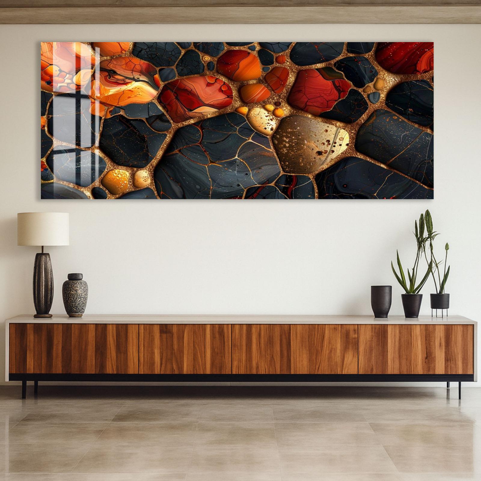 a large abstract painting with a striking color palette of red, orange, and black, displayed on a wall above a wooden cabinet.