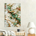 a wall art piece with a marble texture and gold accents, hanging above a wooden table with a lamp and a coffee cup on it.