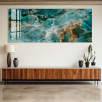 a large abstract painting with a blue and orange color scheme, hanging on a wall above a wooden cabinet. The cabinet has a dark finish and is adorned with two black vases and two potted plants.