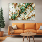 a large abstract painting with a mix of green, white, and gold colors, depicting a pattern of leaves and flowers. The painting is displayed on a wall above a cozy living room setting with an orange sofa, a coffee table, and a potted plant.