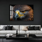 a large, close-up of a bird of prey, such as an eagle or hawk, with its sharp beak and piercing eyes. The bird is positioned in the center of the frame, drawing the viewer's attention to its striking features. The background is dark, which contrasts with the bird's colors and makes it stand out even more. The image is displayed on a wall above a white couch, creating a striking visual focal point in the room.