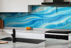 a kitchen with marble counter tops and a blue wave backsplash