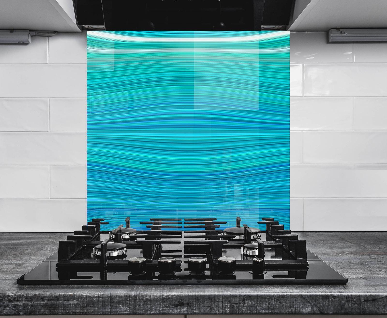 a modern kitchen with a sleek black gas range and a striking blue and white striped wall behind it.