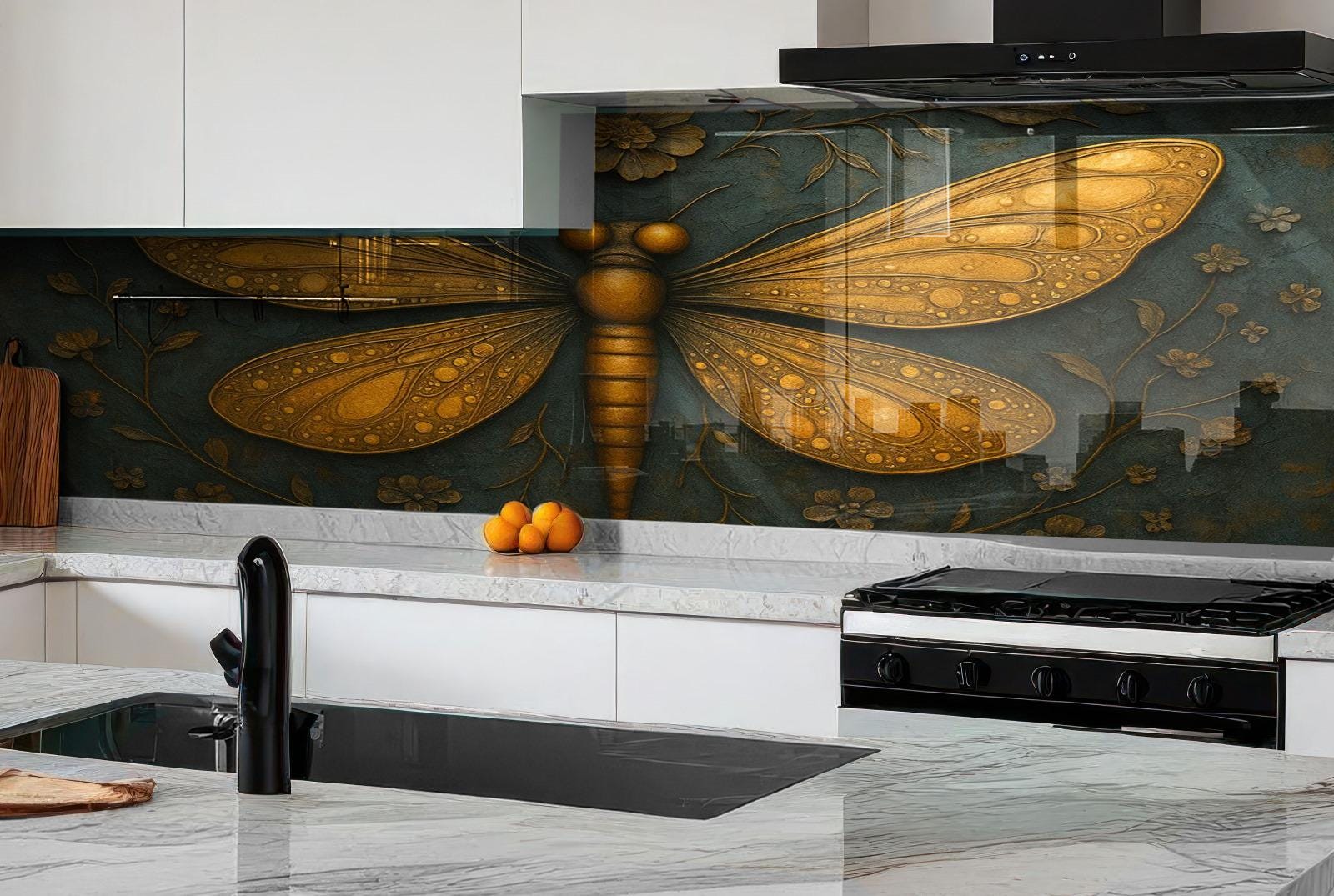 a kitchen with a large, detailed dragonfly mural on the wall behind the stove. The dragonfly has golden wings and a black body, and it is surrounded by green leaves and flowers. The kitchen has white cabinets and a black stove, and there are some oranges and a cutting board on the counter.