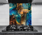 a modern kitchen with a striking backsplash that showcases a vibrant abstract design in shades of blue, gold, and brown. The backsplash is positioned above a gas stove, creating a visually appealing contrast between the functional and artistic elements of the space.