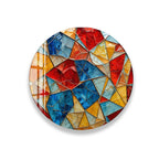 The image is a vibrant, colorful mosaic composed of various geometric shapes and patterns, including triangles, rectangles, and circles, arranged in a circular pattern.