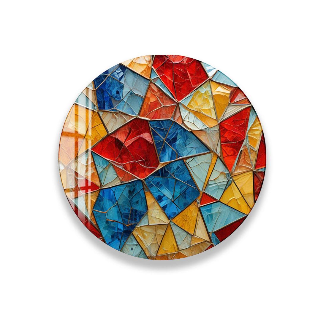 The image is a vibrant, colorful mosaic composed of various geometric shapes and patterns, including triangles, rectangles, and circles, arranged in a circular pattern.