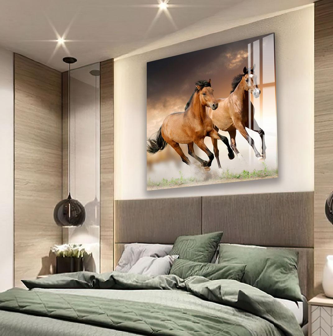 a large, framed photograph of two leopards on the wall above a bed with green bedding.