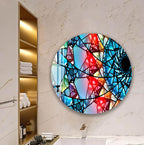 a bathroom with a large, colorful abstract painting hanging on the wall. The painting has a mosaic-like design with various shades of blue, red, and yellow. The bathroom also includes a white marble wall, a bathtub, and a shelf with towels.