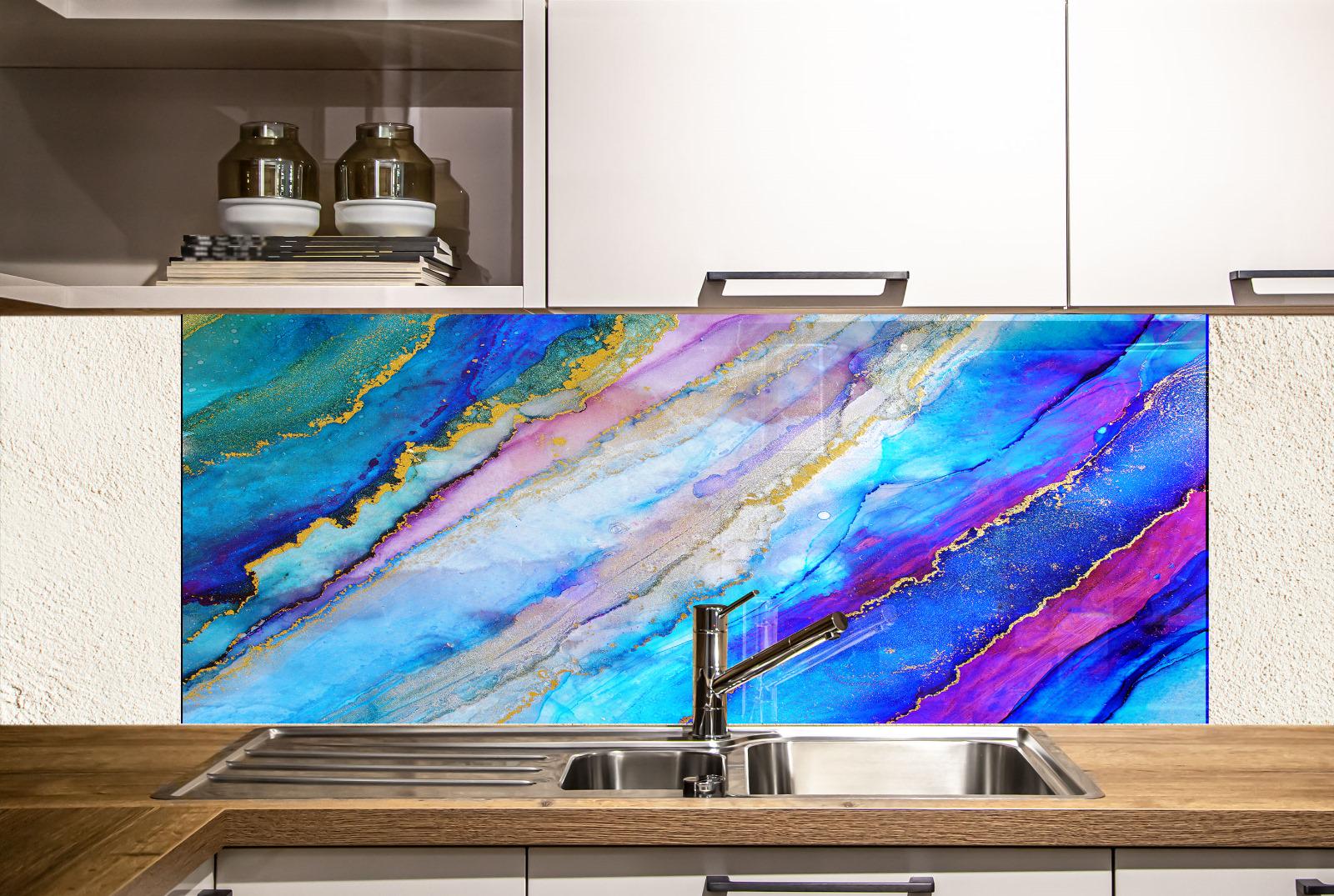 a kitchen with a colorful backsplash behind the sink, which has a vibrant abstract design in shades of blue, purple, and pink. The sink is positioned under the backsplash, and there are white cabinets above it.