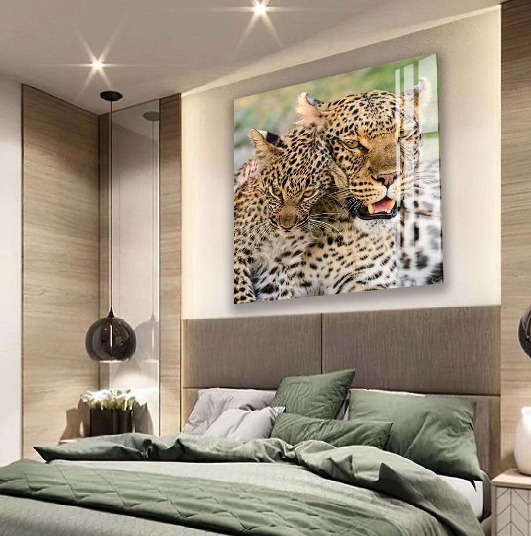 a large black and white tiger portrait hanging on the wall above a bed with green bedding.