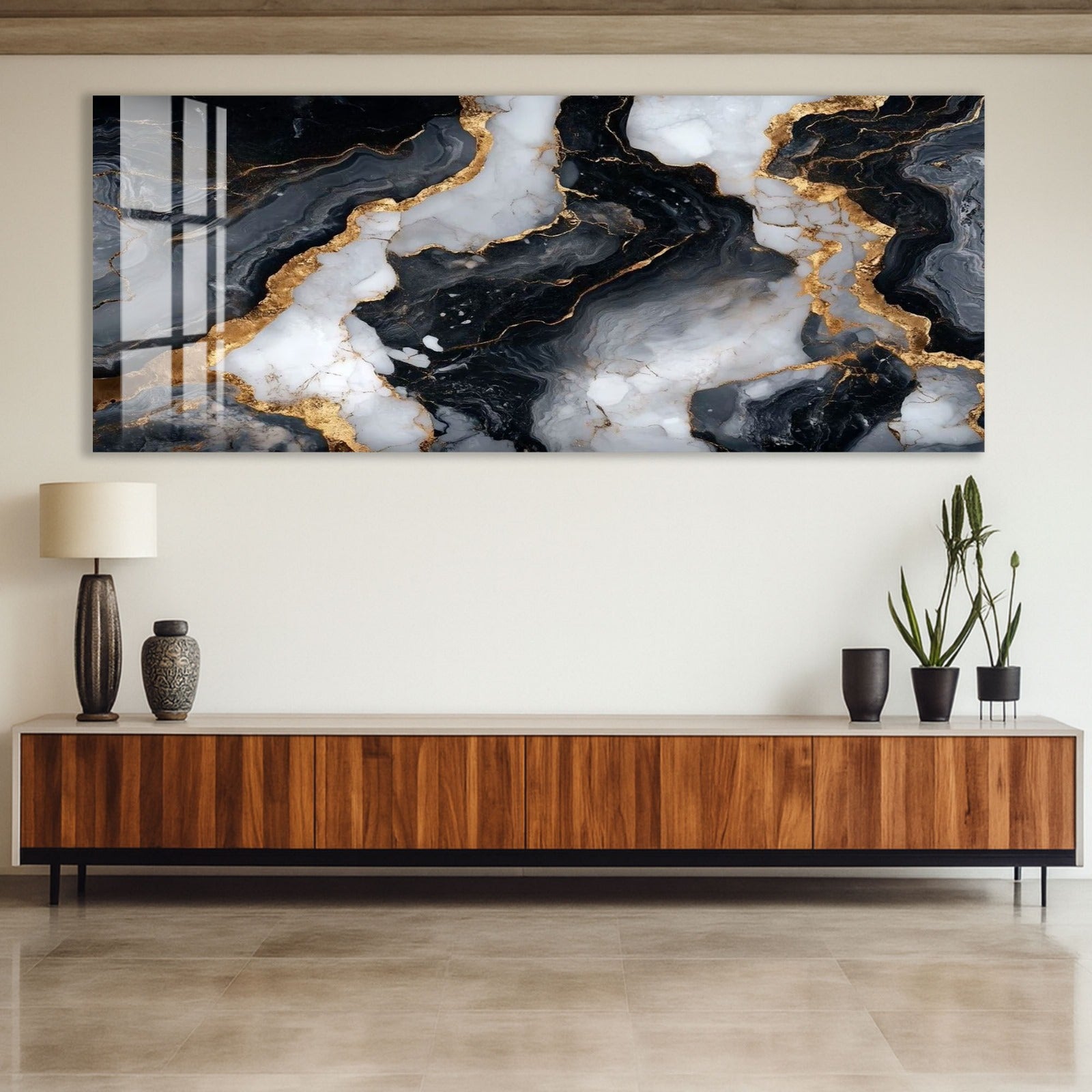a modern interior design with a large abstract painting hanging on the wall above a wooden cabinet. The painting has a striking black and white marble-like pattern with gold accents, creating a visually striking contrast. The cabinet below the painting has a sleek, contemporary design with a dark finish, complementing the overall aesthetic of the room.