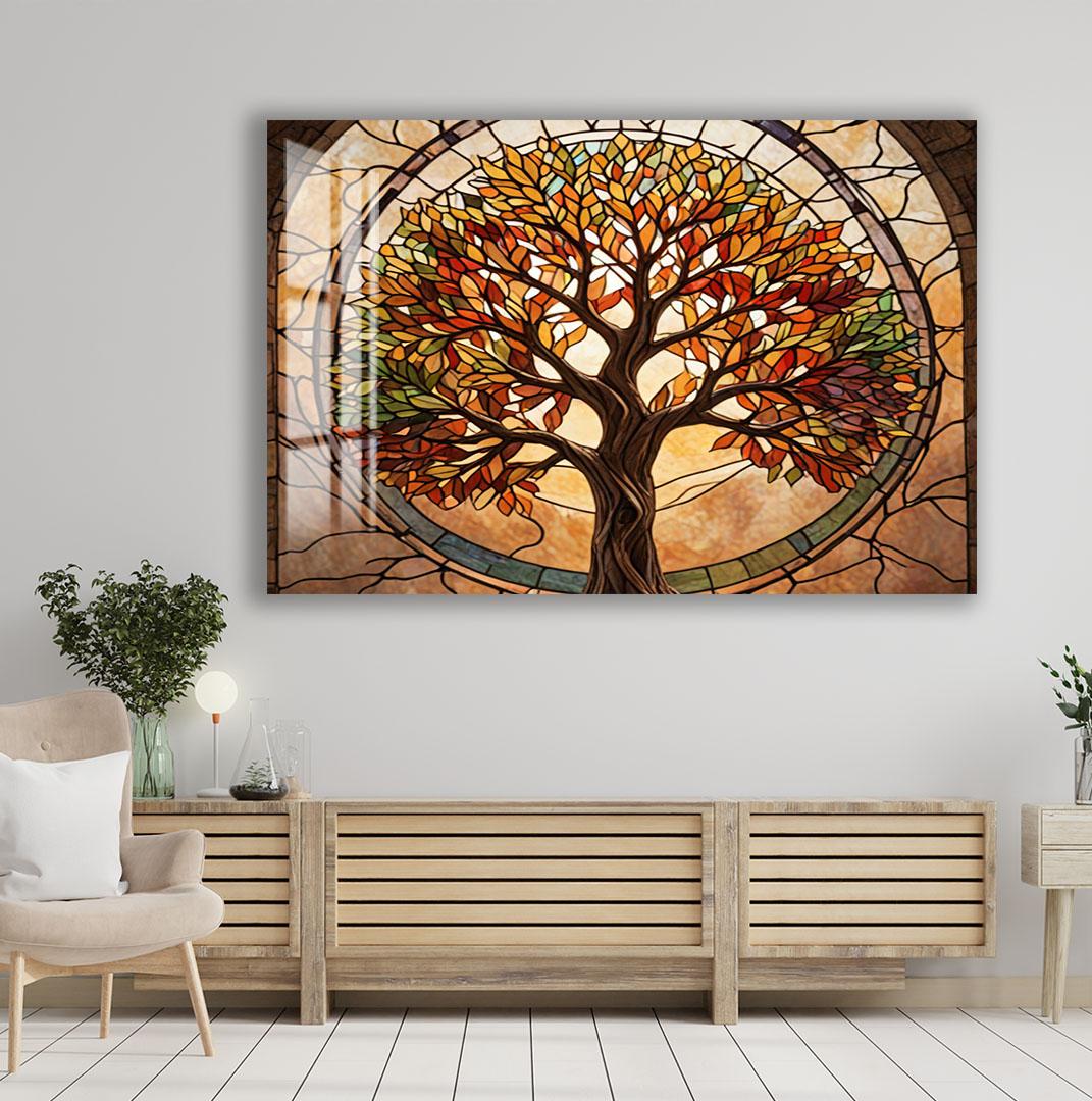 a large, colorful stained glass artwork depicting a tree with vibrant autumn leaves, hanging on a wall above a wooden cabinet or console.