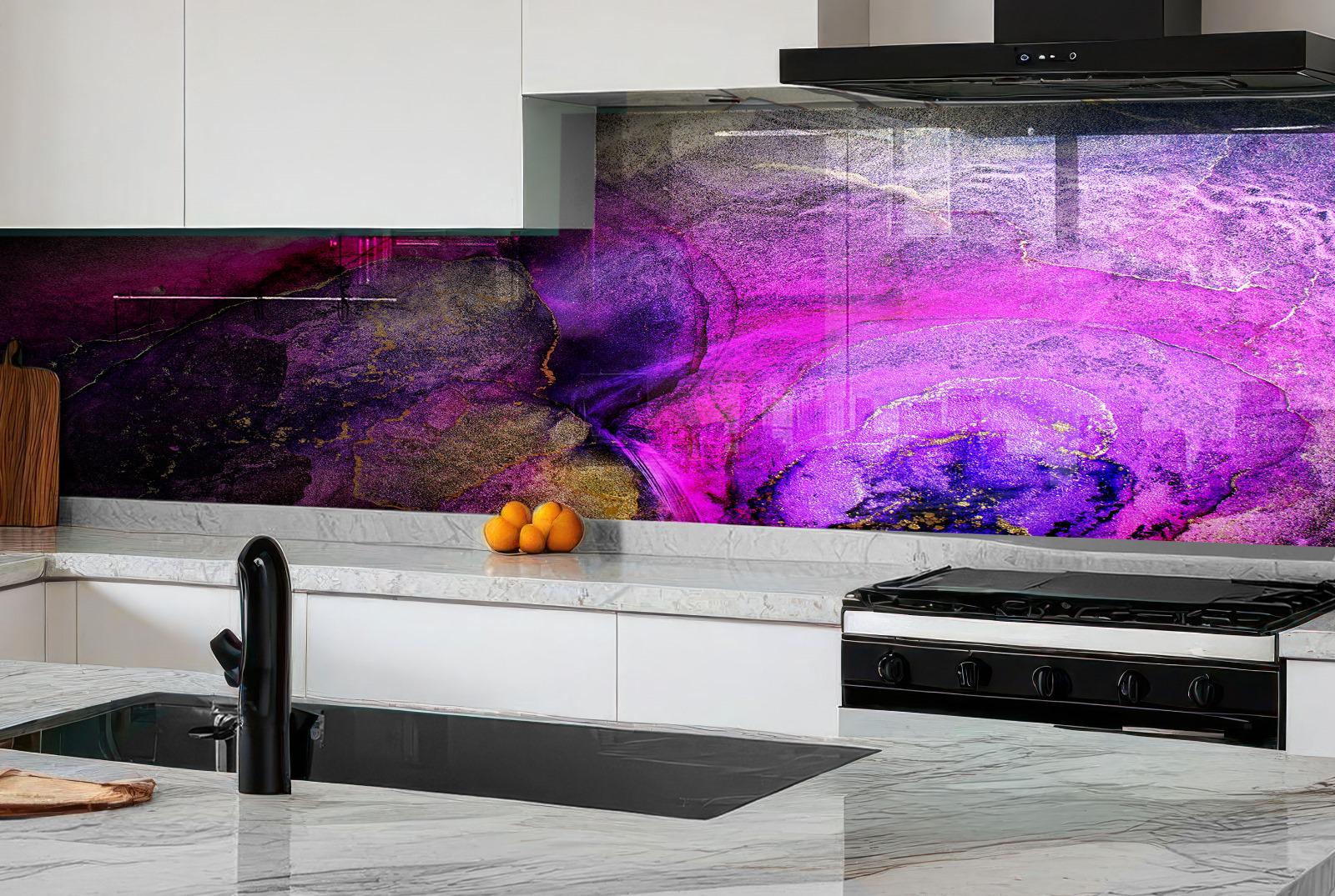 a modern kitchen with a large, colorful abstract painting on the wall behind the stove. The painting has a mix of purple, pink, and orange colors, creating a vibrant and lively atmosphere. The kitchen has white cabinets and a black stove, providing a striking contrast to the colorful artwork. On the countertop, there are a few oranges and a wooden cutting board, adding a touch of warmth and natural elements to the overall design.