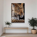a large, detailed painting of a leopard's face hanging on a white wall. Below the painting, there is a wooden bench and a potted plant, creating a cozy and inviting atmosphere.