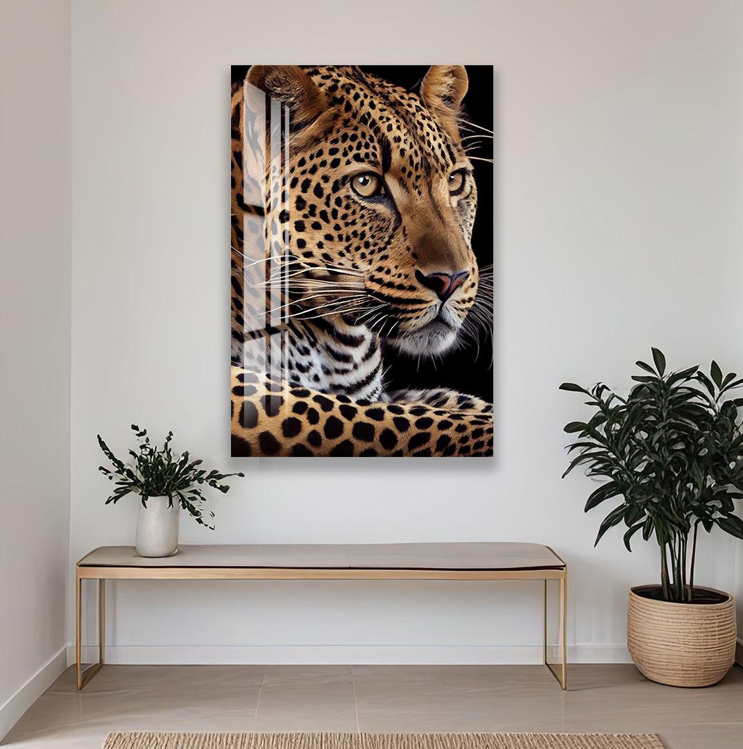 a large, detailed painting of a leopard's face hanging on a white wall. Below the painting, there is a wooden bench and a potted plant, creating a cozy and inviting atmosphere.