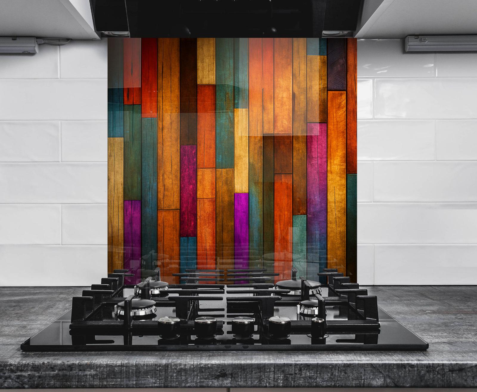 a stove top with a multicolored wall behind it