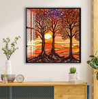 a framed stained glass artwork depicting a serene landscape with three trees with roots extending into the ground, set against a sunset-like background. The artwork is hung on a wall above a wooden dresser, which also holds a clock, a vase with flowers, and a stack of books.