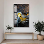 a close-up of a bird of prey, such as an eagle, with its sharp beak and piercing eyes. The bird is captured in a striking close-up shot, showcasing its intricate features and the intensity of its gaze. The image is framed by a white wall, and a wooden bench is positioned in front of it, with a potted plant nearby.