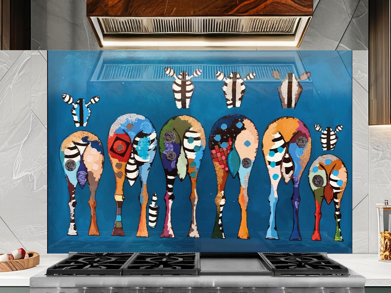 a vibrant and colorful abstract painting of various animal shapes and patterns, including zebras, giraffes, and other wildlife, displayed on a wall above a stovetop.