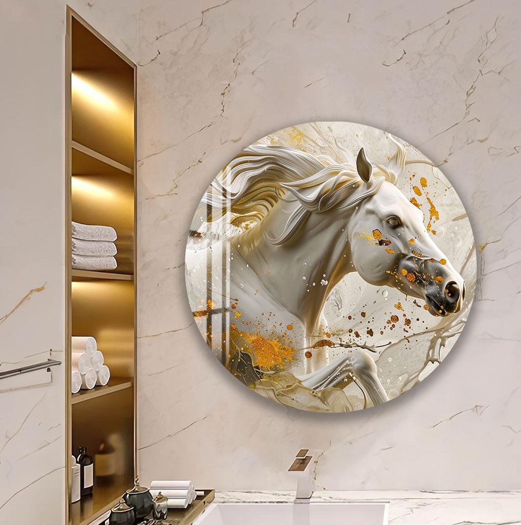 A round mirror in a bathroom displays two colorful toucans perched on a branch, with a shelf of towels and toiletries visible to the left.