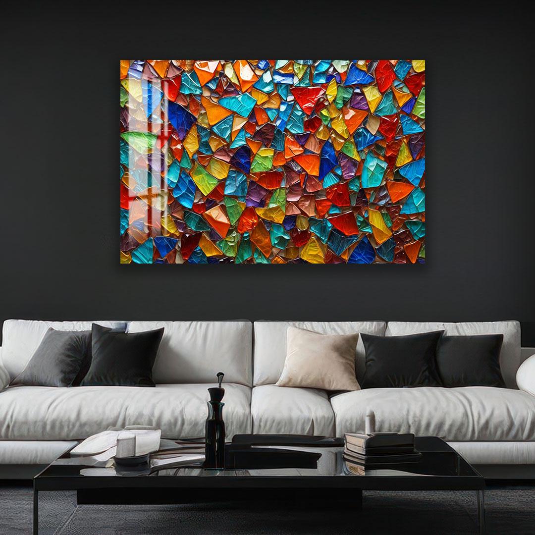 a large, colorful mosaic artwork displayed on the wall above a white sofa in a living room setting.