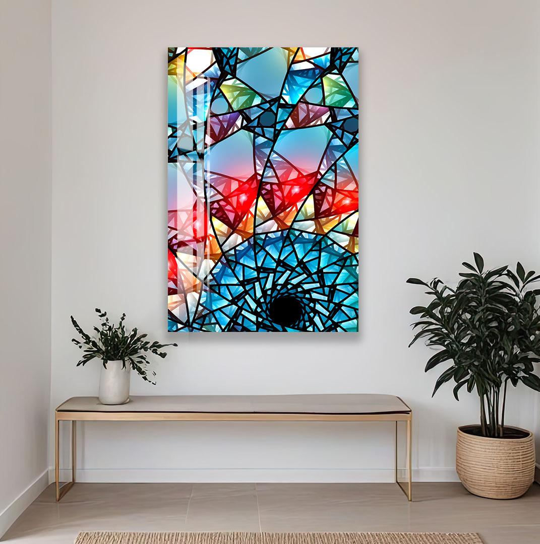 a vibrant abstract painting hanging on a white wall, with a wooden bench and potted plants in the foreground.