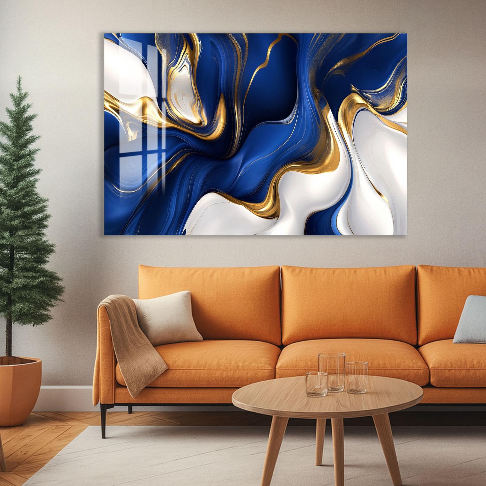 a modern living room with a large abstract painting hanging on the wall above a cozy orange sofa. The painting has a striking combination of blue and gold colors, creating a visually captivating display. In front of the sofa, there is a wooden coffee table with a glass top, and a potted plant is placed on the floor next to the sofa.