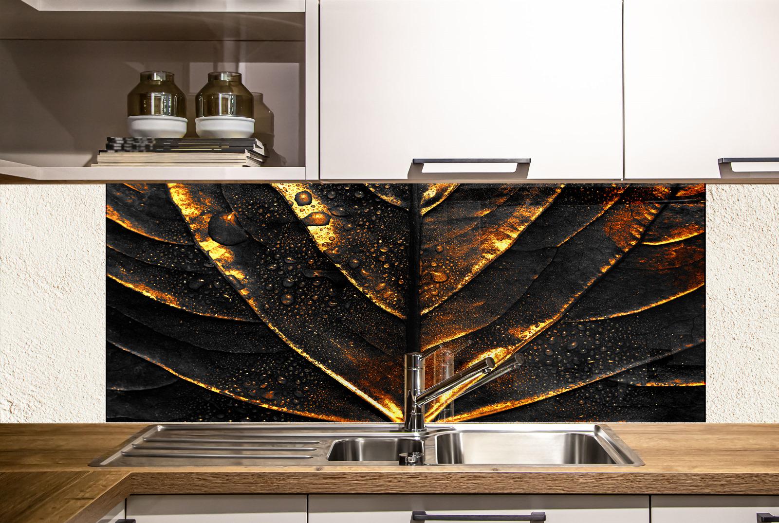 a kitchen with a black and gold leaf-like design on the wall behind the sink, creating a striking visual effect.