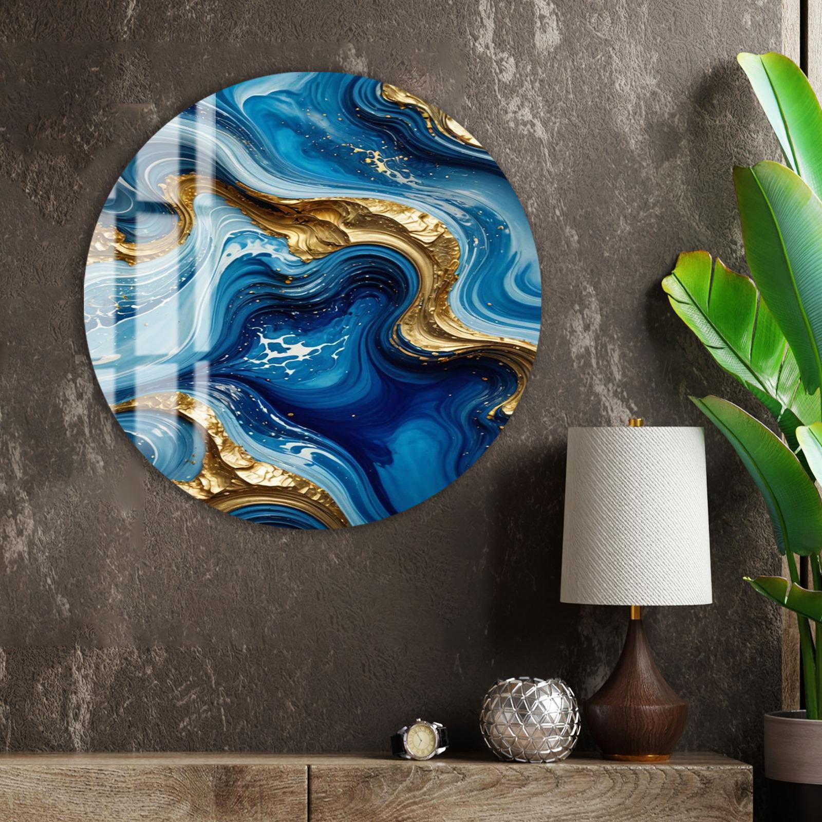 a large circular wall art piece with a swirling pattern of blue and gold colors, hanging on a wall next to a wooden shelf with a lamp and a plant.