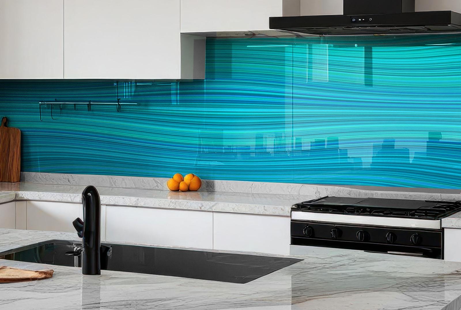 a modern kitchen with a sleek black stove and a countertop with a sink and a few oranges. The kitchen has a white and black color scheme, and the backsplash is a vibrant blue with a wavy pattern.