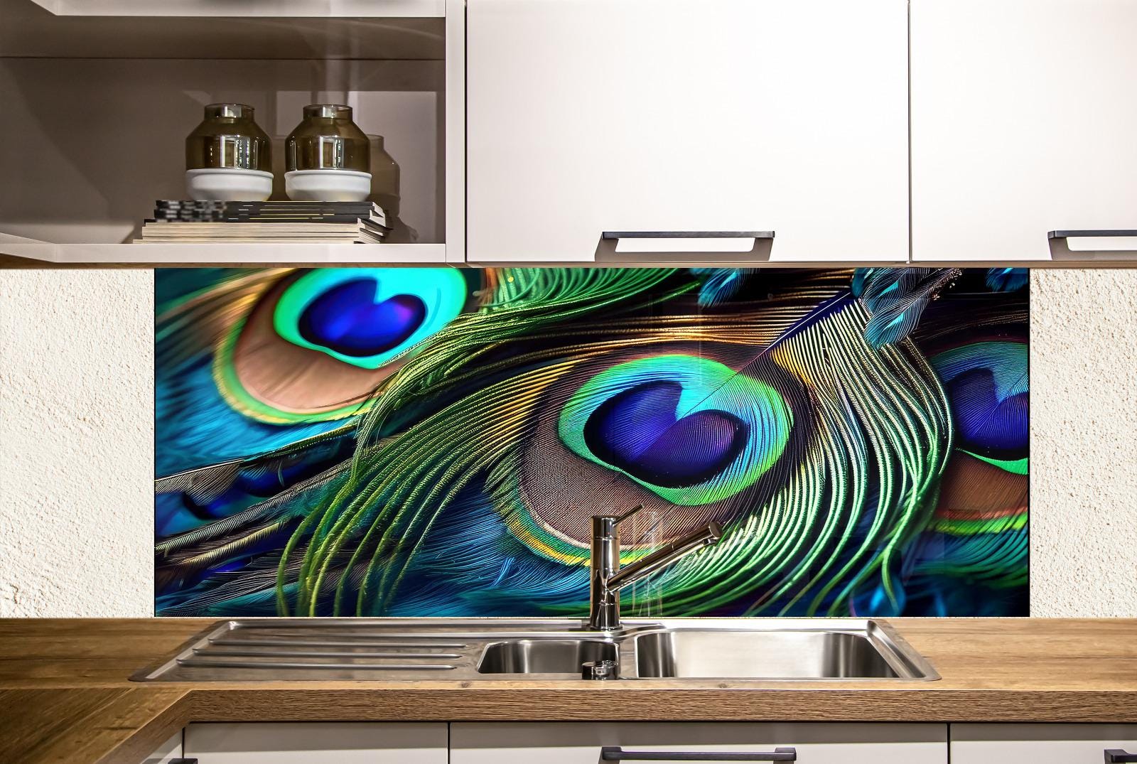 a kitchen with a large, colorful backsplash that showcases the intricate details of peacock feathers. The backsplash is a striking contrast of blue, green, and orange hues, creating a visually captivating display. The kitchen itself has white cabinets and a stainless steel sink, providing a clean and modern aesthetic.
