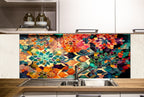 a kitchen with a sink and a colorful tile backsplash