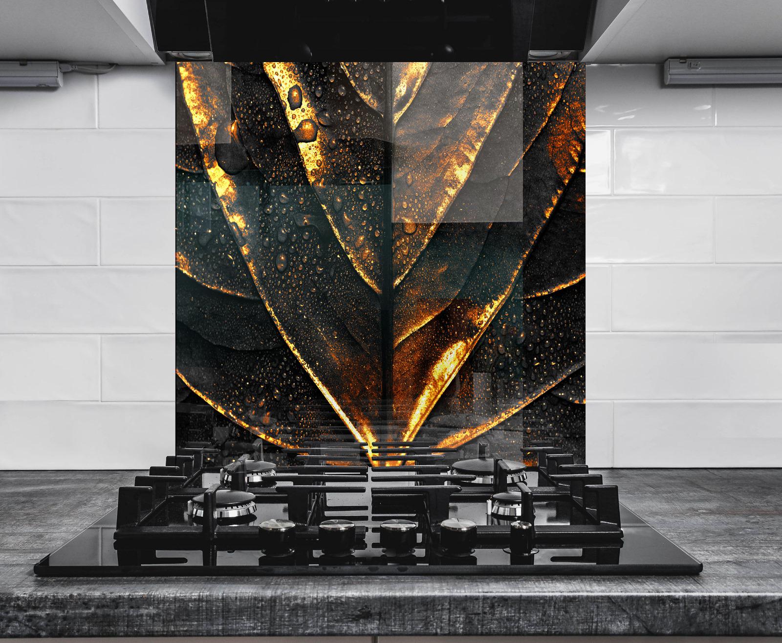 a modern kitchen with a striking black and gold design on the wall behind the gas stove.