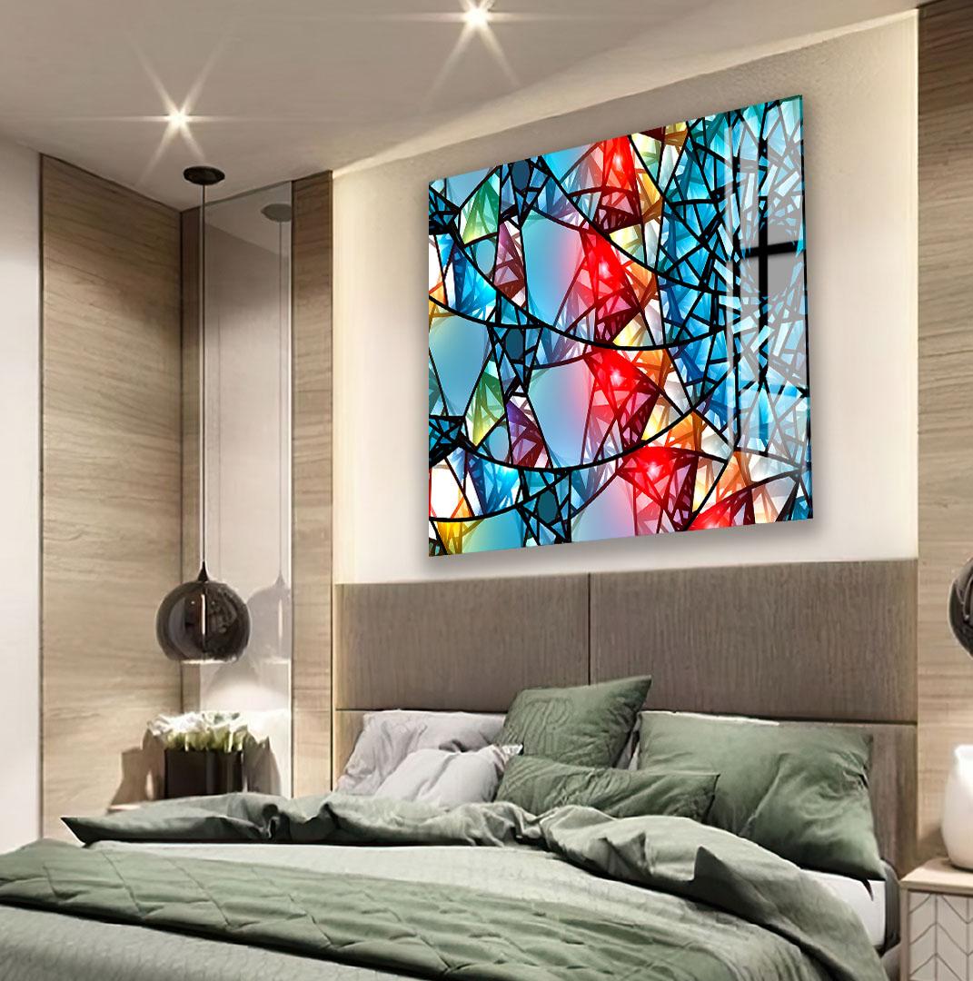 a modern bedroom with a large, colorful abstract painting hanging on the wall above a bed with a green comforter.