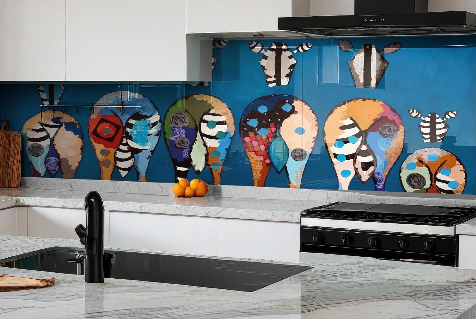 a kitchen with a vibrant backsplash that showcases a collection of colorful animal heads and shapes, including zebras, giraffes, and elephants. The backsplash is set against a blue wall, creating a striking contrast. The kitchen is equipped with a stove, sink, and various kitchen accessories, including oranges and a cutting board.