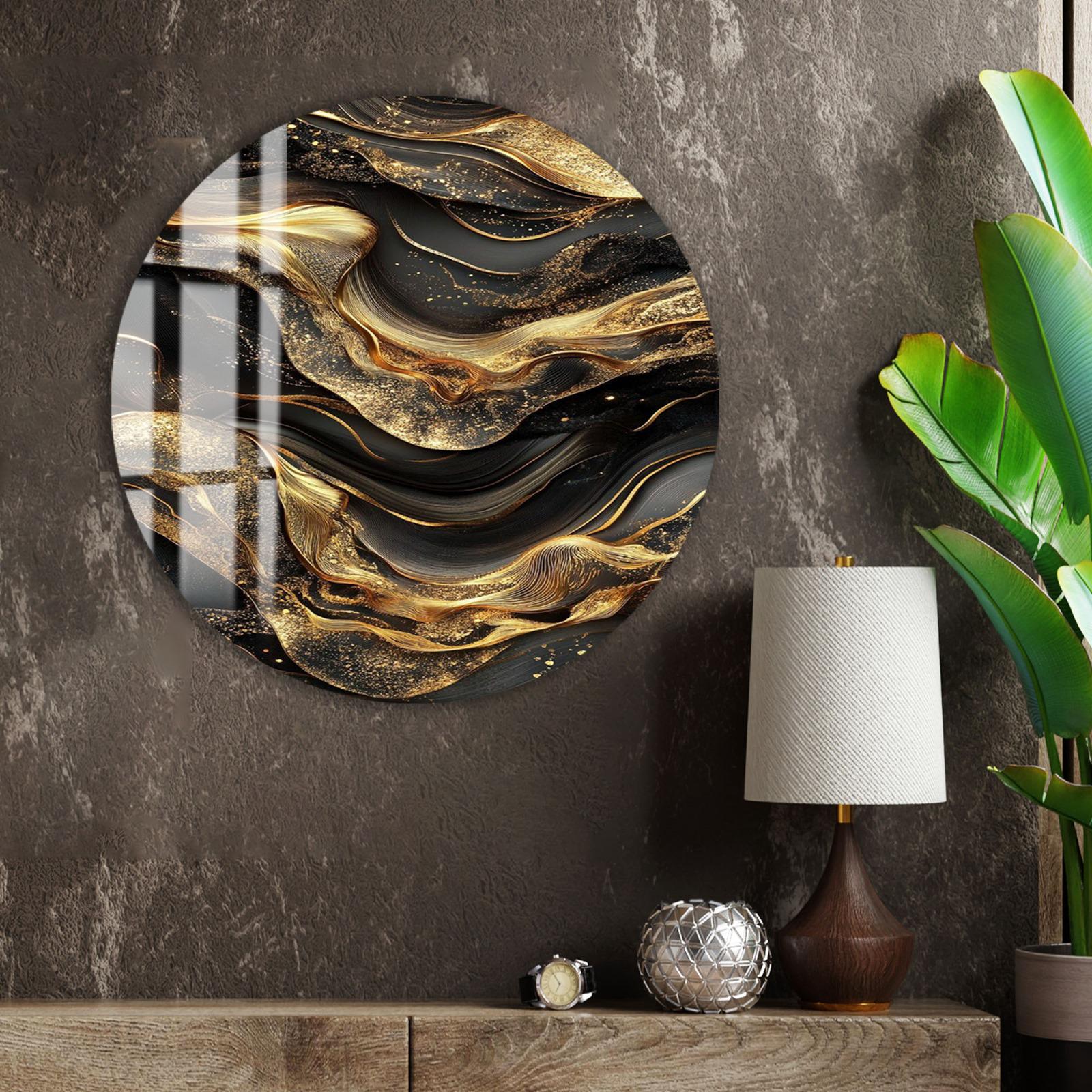 a large circular wall art piece with a gold and black abstract design, hanging on a wall next to a lamp and a plant.