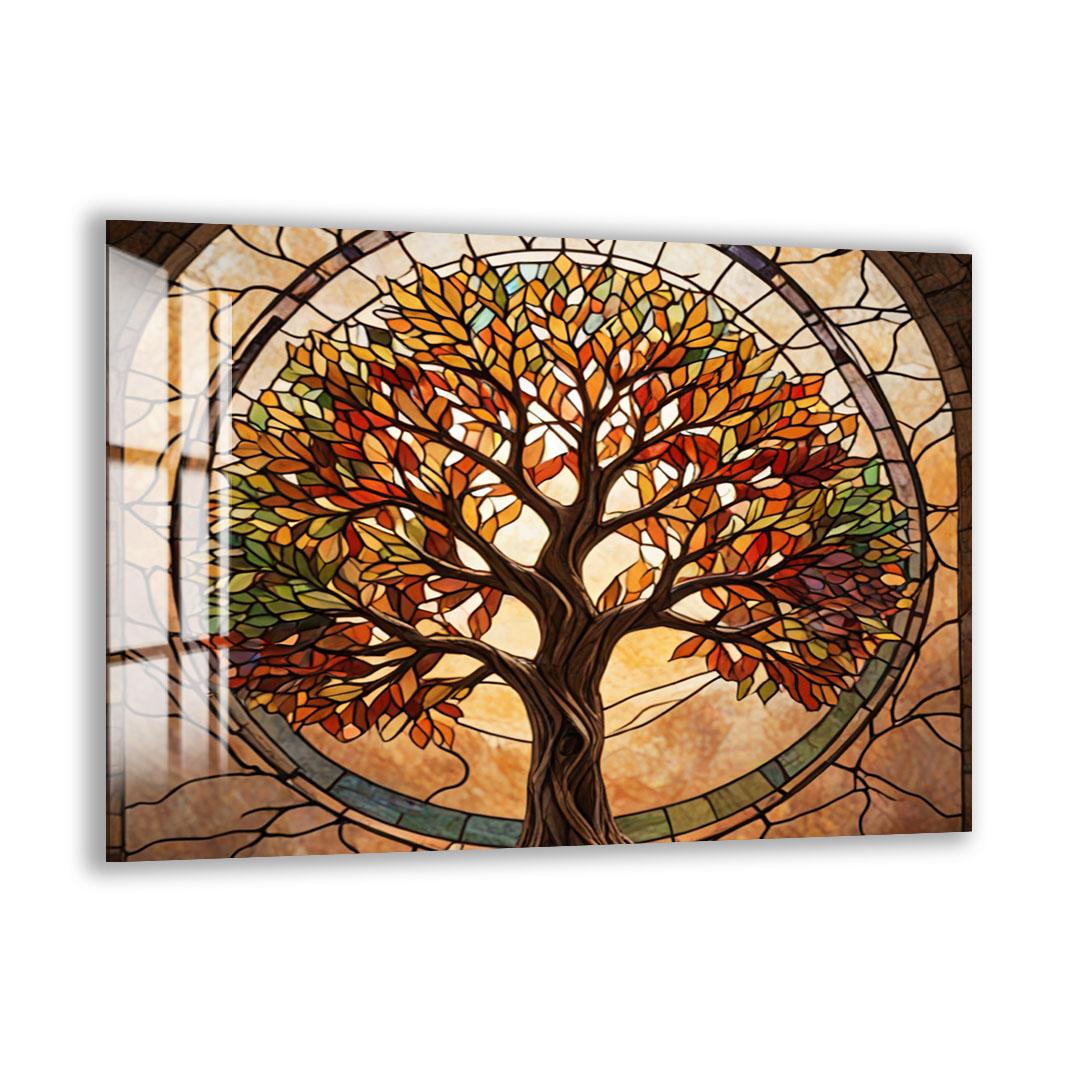 A stained glass artwork depicting a tree with vibrant autumn leaves, encased within a circular frame.