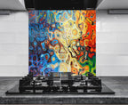 a vibrant, abstract painting with swirling patterns of blue, orange, yellow, and red colors, creating a dynamic and energetic visual effect. The painting is displayed on a wall behind a black stovetop, which is positioned in front of a white countertop. The stovetop has a black griddle on top, adding a modern and sleek touch to the overall design.
