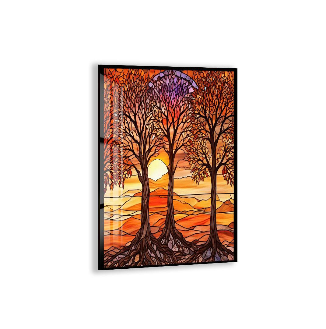 A stained glass artwork depicting a serene landscape with three trees with intricate, colorful patterns against a backdrop of a sunset.